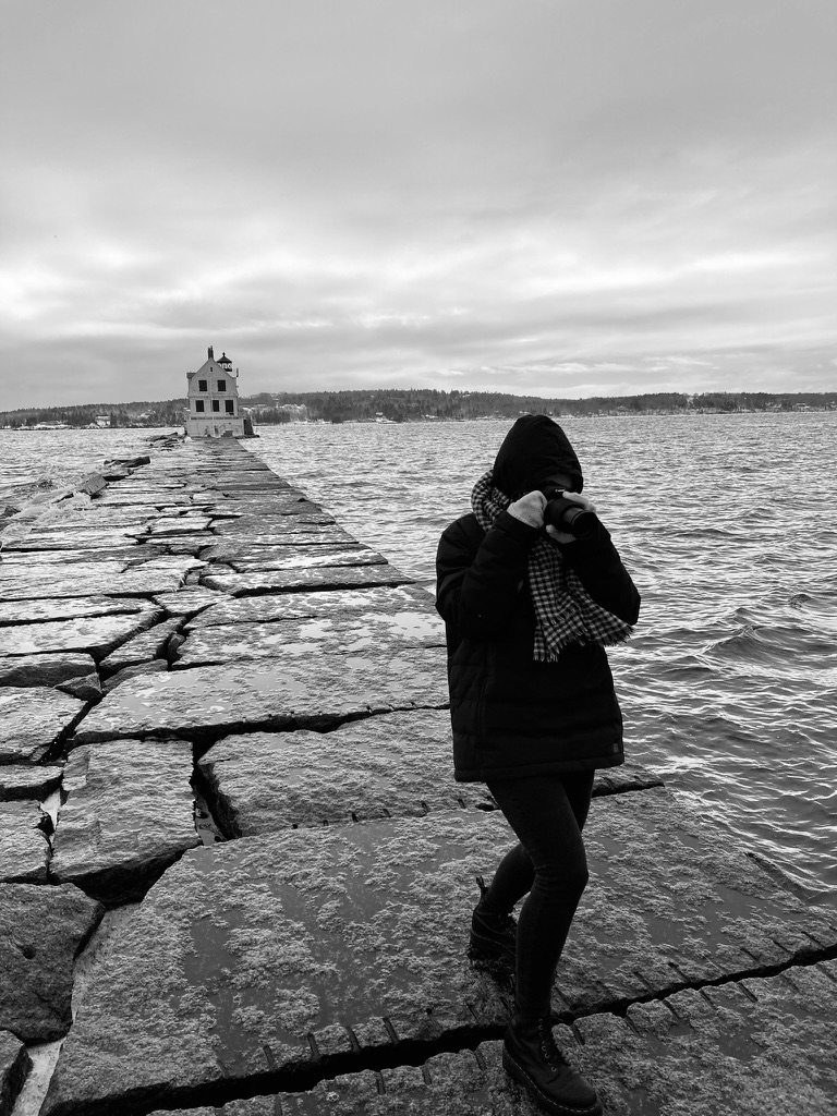 Alena taking a photograph by the water
